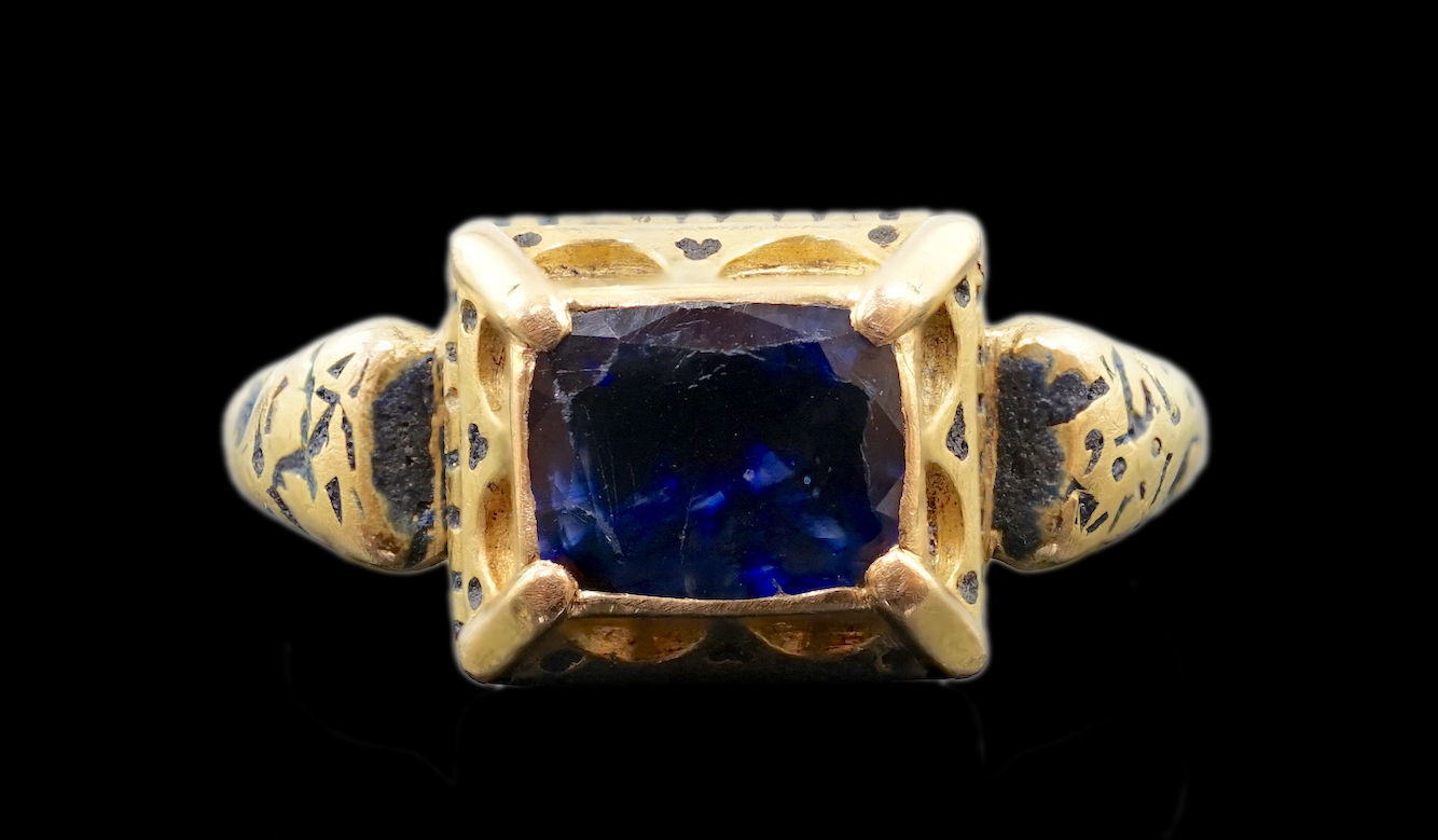 An antique high carat gold, black enamel and collet set cushion cut sapphire set 'poison' ring